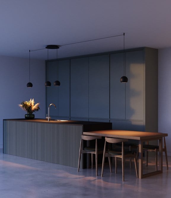 Pendant lighting above green kitchen counter top in the evening